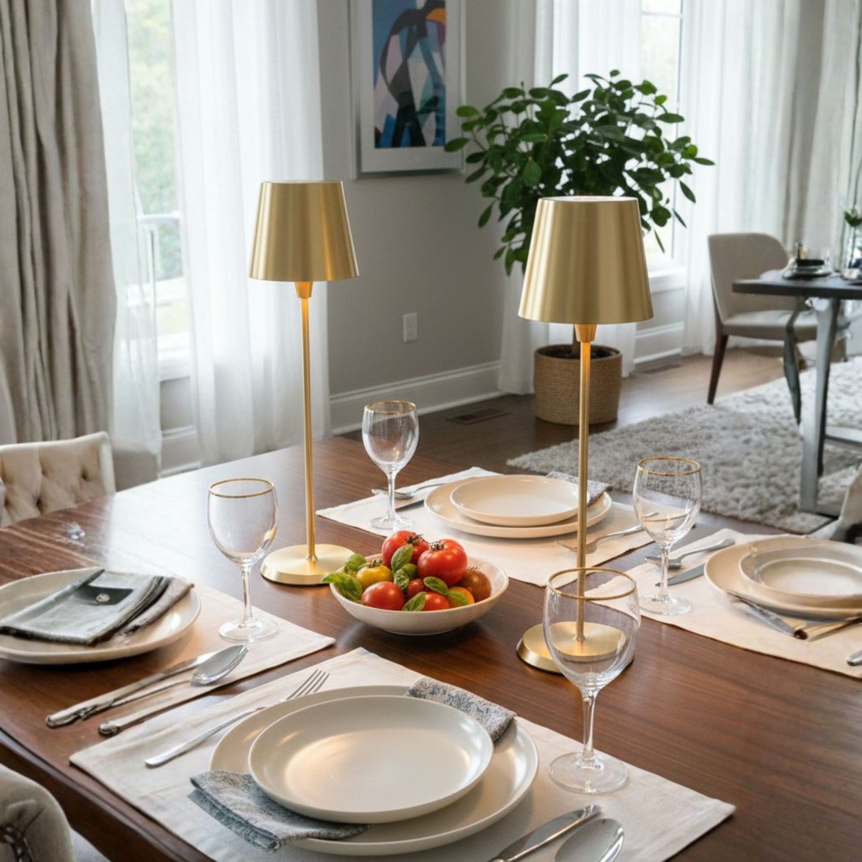 Selene Table Lamp in champagne gold, elegantly placed on a dining table set with plates and glasses.